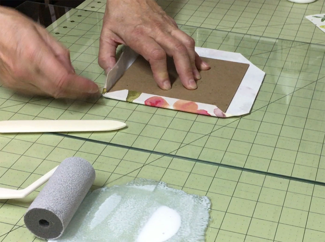 Fold the margins and the corners of your book covers