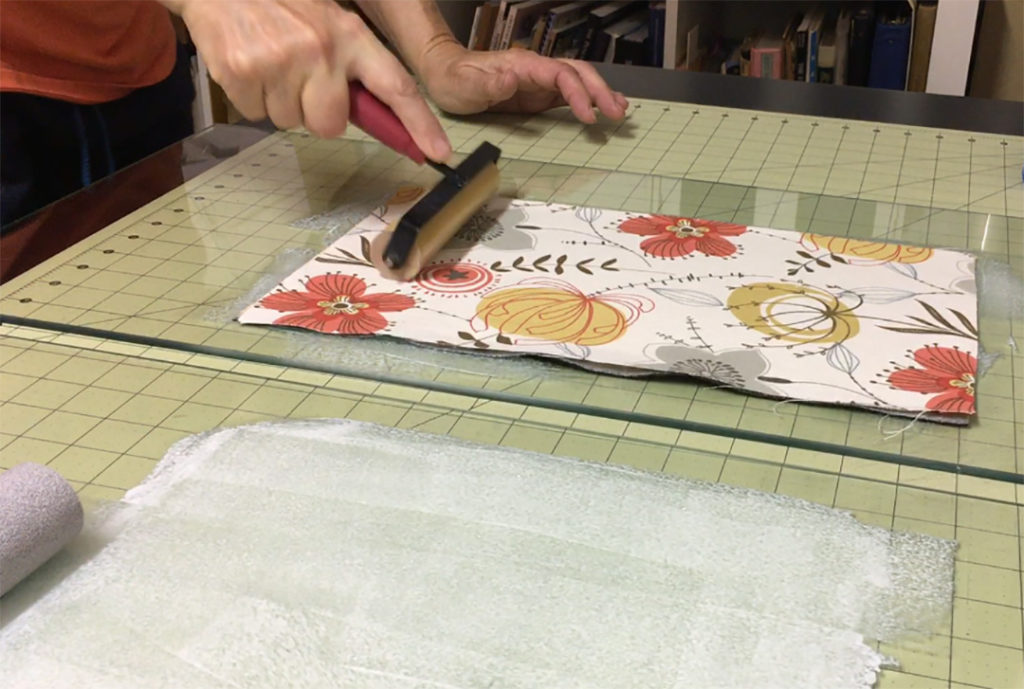 Using Brayer to Adhere Fabric to Back of Faux Leather Wrapped Journal