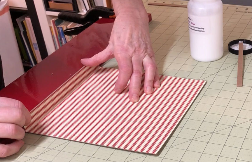 Place Glued Side on Board Using Backstop for Slipcase Construction